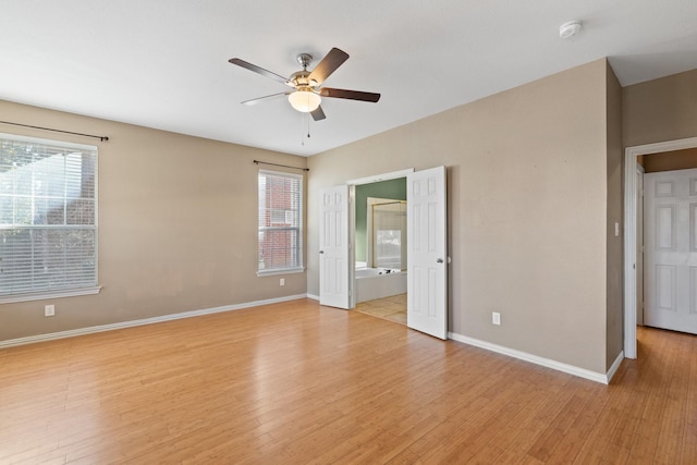 unfurnished room with light hardwood / wood-style flooring, plenty of natural light, and ceiling fan