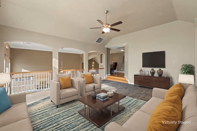 living room featuring hardwood / wood-style flooring, ceiling fan, lofted ceiling, and ornamental molding