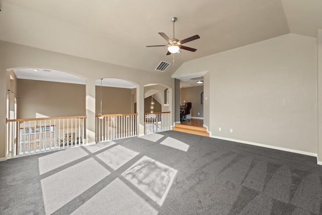 carpeted spare room featuring ceiling fan, lofted ceiling, and ornamental molding