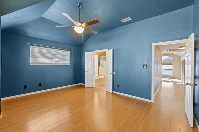 unfurnished bedroom featuring ceiling fan, light wood-type flooring, and lofted ceiling