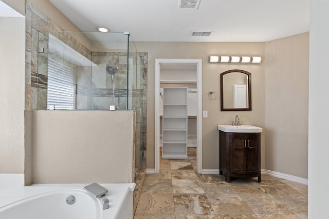 bathroom featuring vanity and shower with separate bathtub