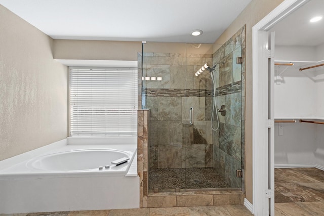 bathroom featuring independent shower and bath