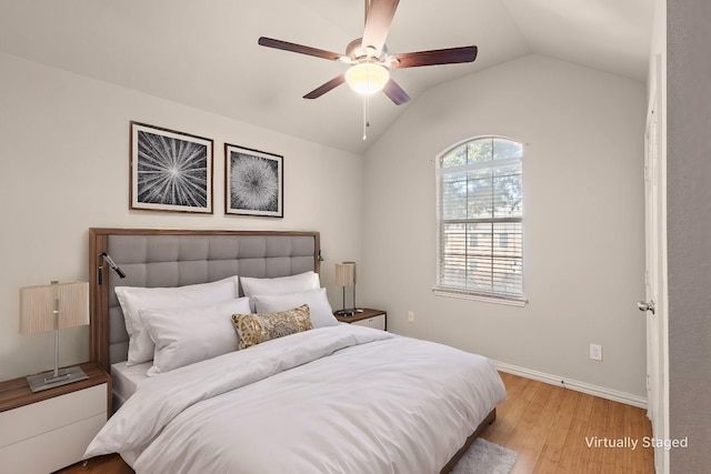 bedroom featuring vaulted ceiling, light hardwood / wood-style flooring, and ceiling fan