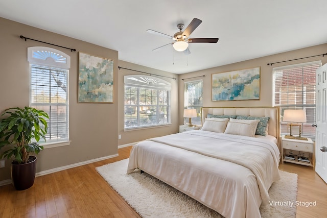 bedroom with ceiling fan and light hardwood / wood-style floors