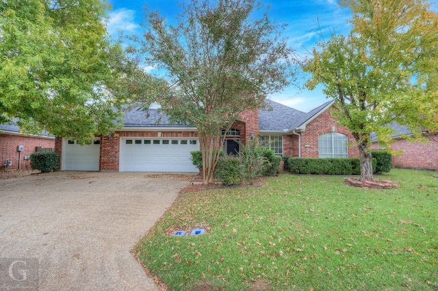 ranch-style house featuring a garage and a front yard