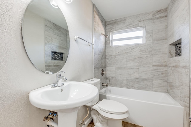 full bathroom with sink, toilet, and tiled shower / bath