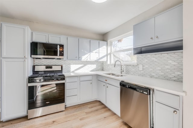 4416 Motley Dr, Mesquite, TX 75150 - kitchen featuring stainless steel appliances, a sink, light countertops, and tasteful backsplash