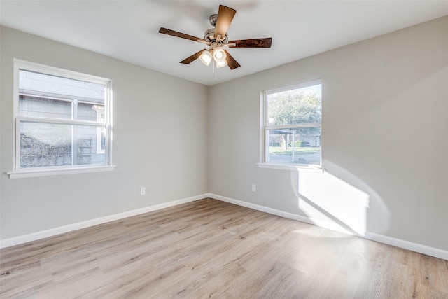 empty room with ceiling fan and light hardwood / wood-style floors