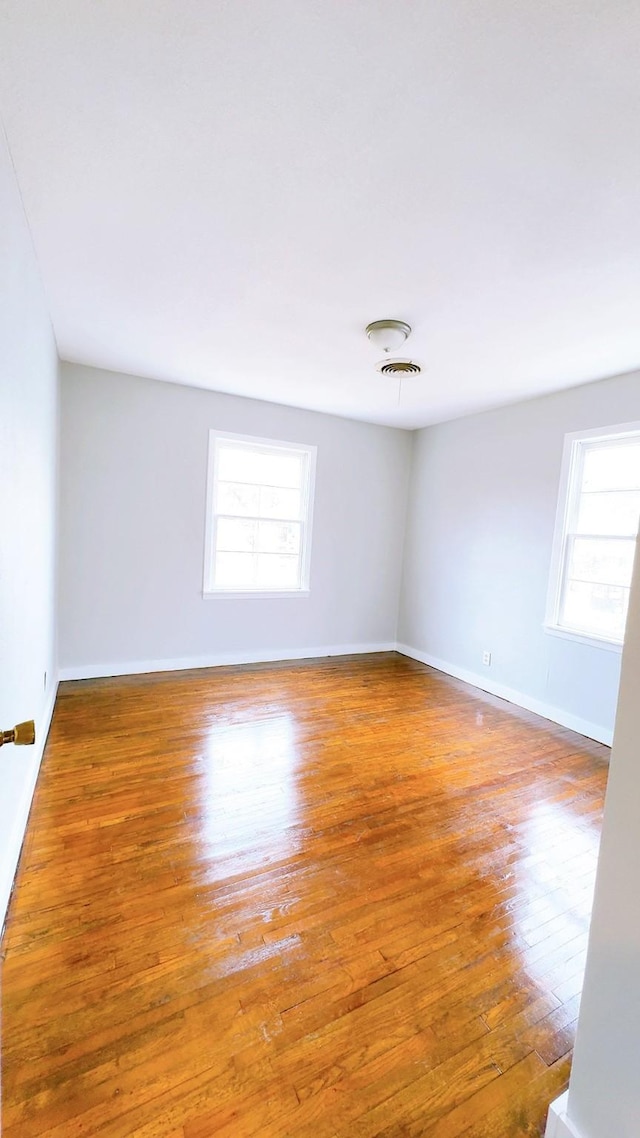 spare room with hardwood / wood-style floors