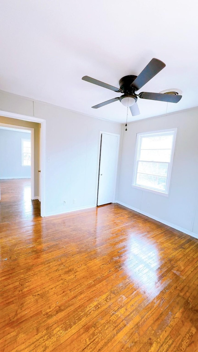 empty room featuring wood-type flooring and ceiling fan