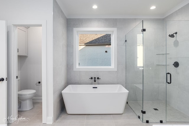 bathroom featuring tile patterned flooring, a stall shower, and toilet