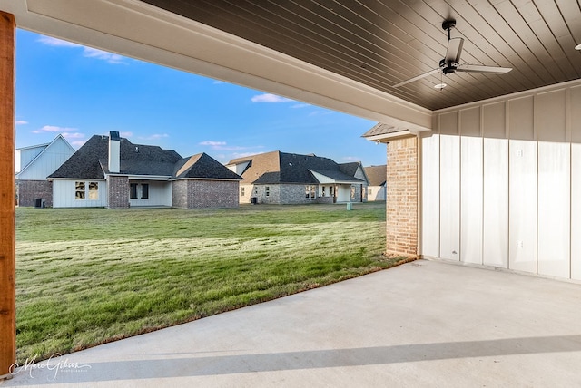 view of yard with a residential view and ceiling fan