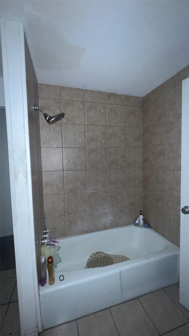 bathroom featuring tile patterned flooring and tiled shower / bath