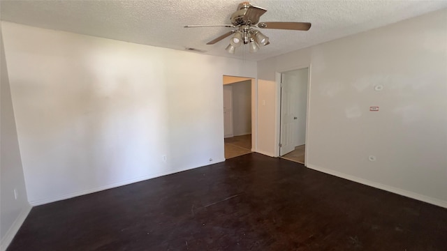 empty room featuring ceiling fan and a textured ceiling