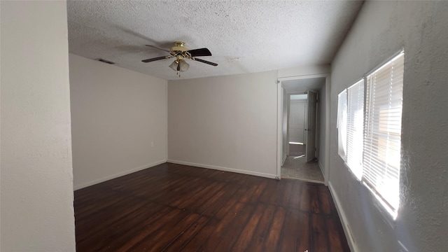 spare room featuring a textured ceiling, ceiling fan, and dark hardwood / wood-style floors