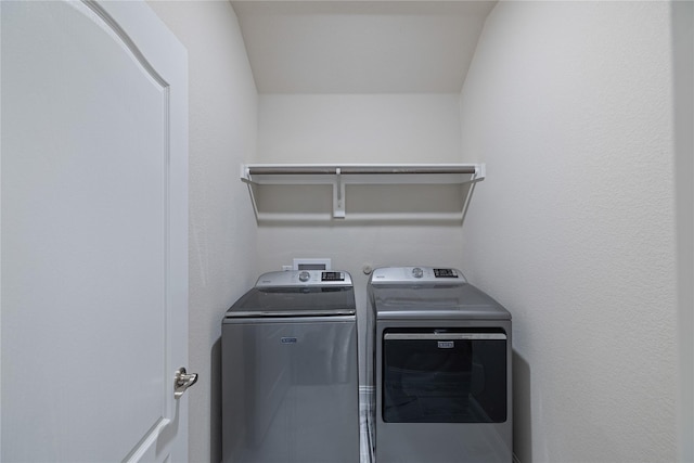 washroom with washing machine and clothes dryer