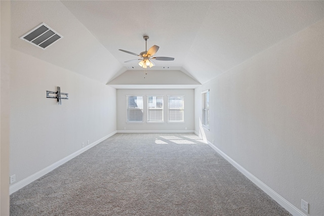 unfurnished living room featuring vaulted ceiling, ceiling fan, and carpet