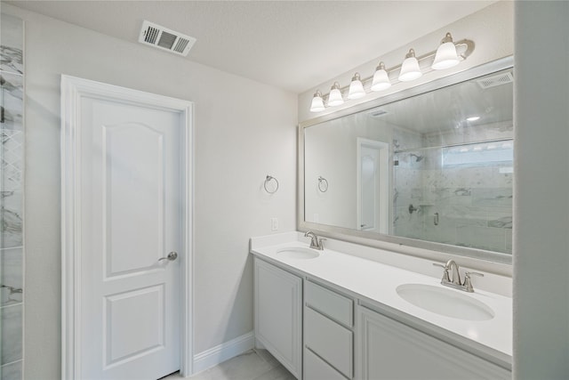 bathroom featuring a shower with door and vanity