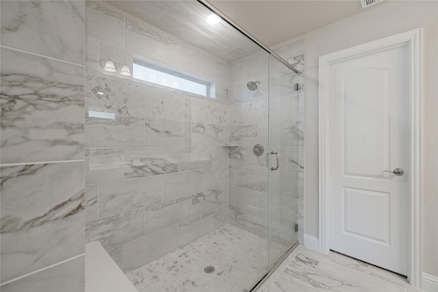 bathroom with a shower with shower door