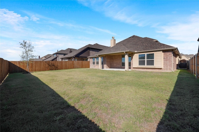 back of property featuring a yard and a patio area