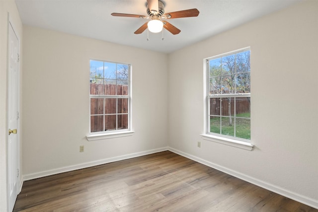 unfurnished room with ceiling fan, plenty of natural light, and hardwood / wood-style floors