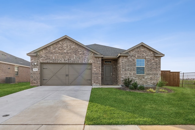 view of front facade with a garage, a front lawn, and cooling unit