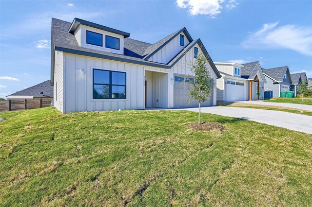 view of front of home with a garage and a front lawn