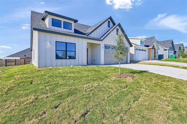 view of front of property featuring a garage and a front yard