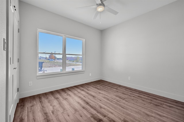 empty room featuring ceiling fan and light hardwood / wood-style flooring