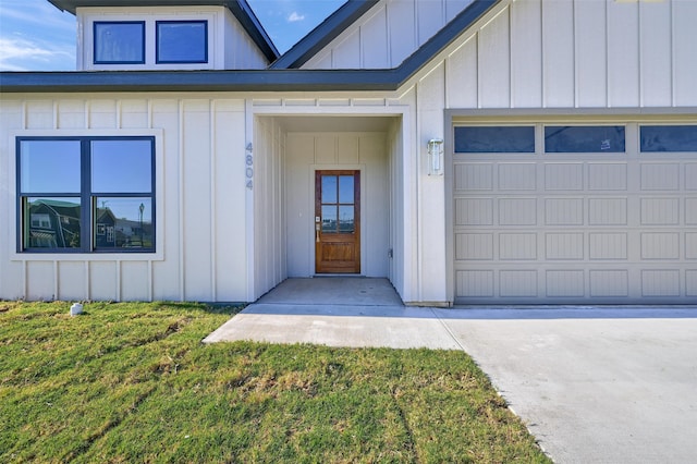 doorway to property featuring a garage and a yard