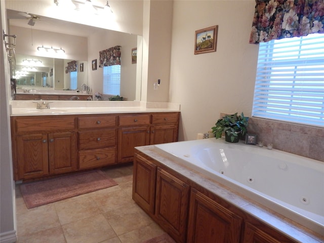 bathroom with a bathing tub, ceiling fan, tile patterned flooring, and vanity