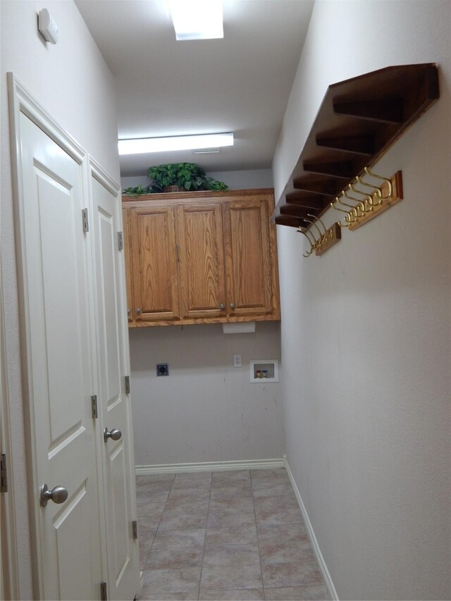 laundry area with cabinets, hookup for a washing machine, hookup for an electric dryer, and light tile patterned flooring