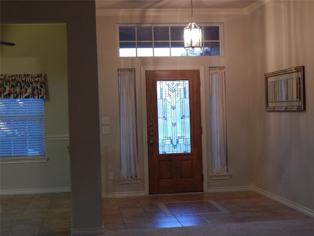 entryway with a chandelier and ornamental molding