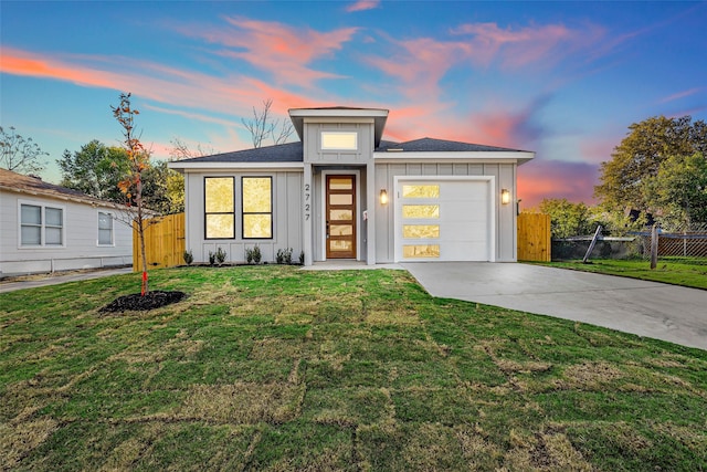 prairie-style home with a lawn and a garage