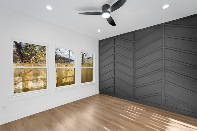 empty room featuring ceiling fan and light hardwood / wood-style floors