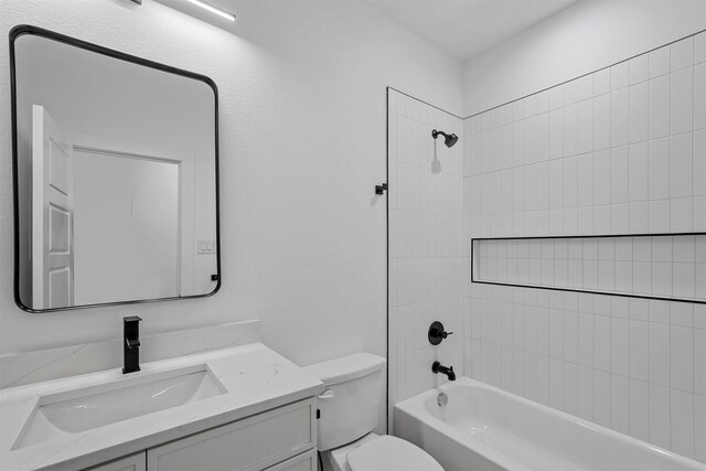 full bathroom with vanity, toilet, and tiled shower / bath