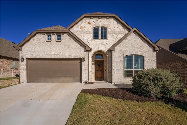 view of front of property featuring a garage and a front yard