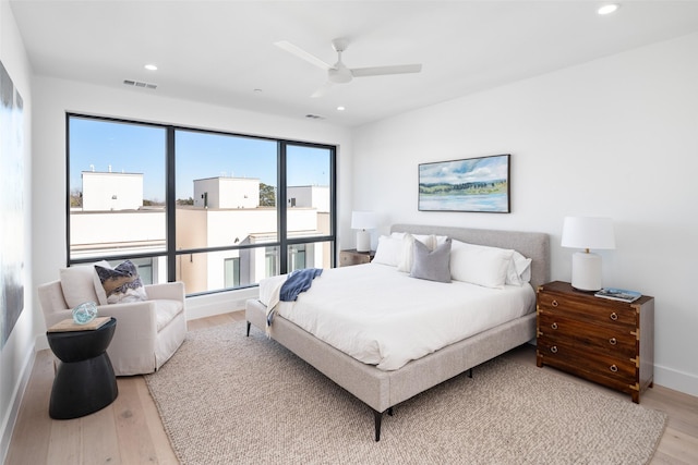 bedroom with ceiling fan and light hardwood / wood-style floors