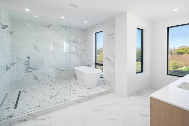 bathroom with vanity and separate shower and tub