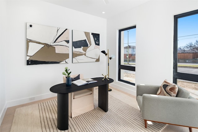 home office with light hardwood / wood-style floors