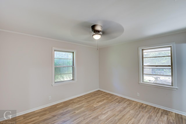 empty room featuring ceiling fan, light hardwood / wood-style floors, and ornamental molding