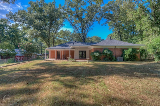 back of house with a lawn