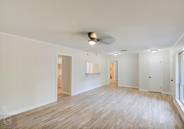 unfurnished room featuring ceiling fan, light hardwood / wood-style floors, and ornamental molding