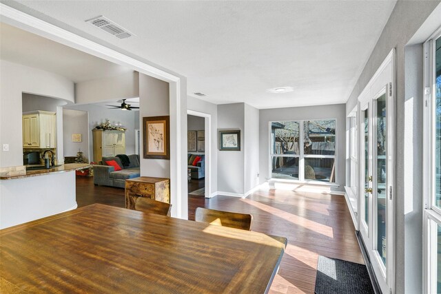 kitchen with decorative light fixtures, dark hardwood / wood-style floors, and a kitchen island