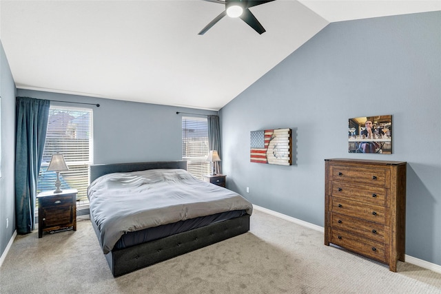 carpeted bedroom with ceiling fan and high vaulted ceiling