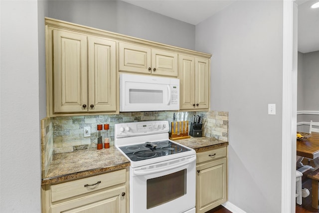 kitchen featuring light brown cabinets, white appliances, and tasteful backsplash