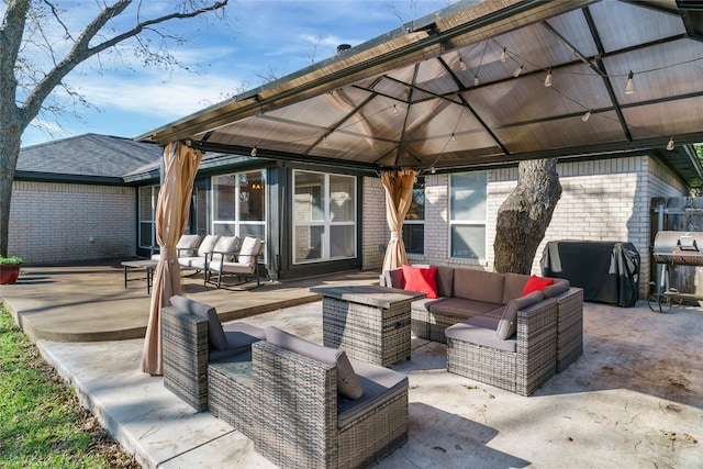 view of patio with a gazebo, a grill, and an outdoor hangout area