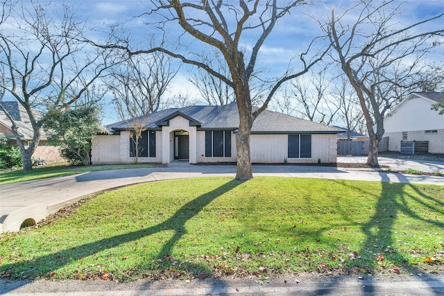 ranch-style home with a front lawn