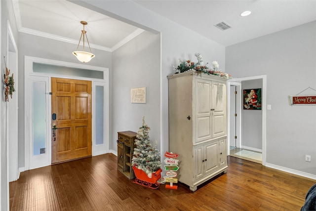 foyer entrance with dark hardwood / wood-style flooring and crown molding