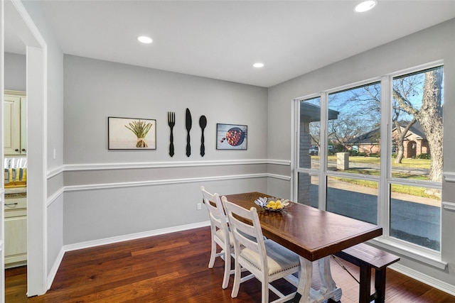 dining space with dark hardwood / wood-style flooring